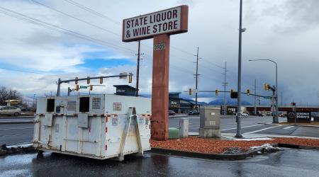 Image of Glass Recycling Container below State Liquor Store sign at Kearns DABS